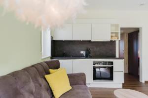 a living room with a couch and a kitchen at Roussel Hotel Restaurant in Bernkastel-Kues