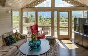 a living room with a couch and a table at Stunning Home In Stranda With Sauna in Stranda