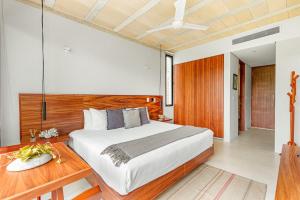 a bedroom with a large bed and a wooden headboard at Fabulous Loft With Pool in Cancún