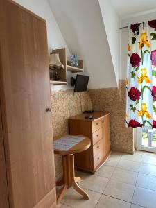 a room with a desk and a cabinet and a window at Pokoje gościnne Becia in Łeba