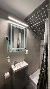 a bathroom with a sink and a mirror and a tub at Amonte Mountain Resort in Muntele Rece +91 photos
