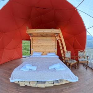a bedroom in a dome tent with a bed and chairs at Glamp Peaks Mestia in Mestia