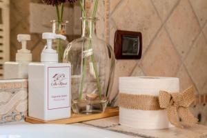 a bathroom counter with a bottle of soap and a candle at Charming&Luxury Villa near Assisi, Service Experience Exclusive in Valfabbrica