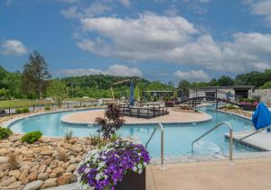 a pool at a resort with purple flowers at The Wolf's Lantern Highway in Pigeon Forge