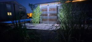 a glass door to a building at night at Owl's Nest in Bar +28 photos