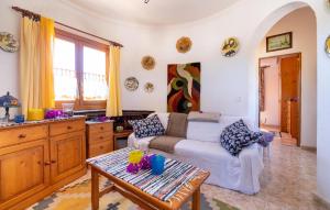a living room with a couch and a table at Sa Torre in Cala Santanyi
