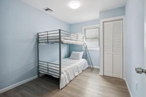 a bedroom with a bunk bed and a ladder at 110 E 24Th Ave, Unit C in Wildwood