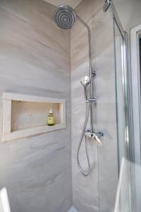a bathroom with a shower with a glass door at Posejdon Apartments in Korčula +50 photos