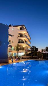 a large swimming pool in front of a building at Summer Gate Hotel in Ksamil