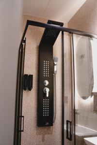 a black appliance is hanging on a wall at Centre Ville Local Stays in Argos +43 photos