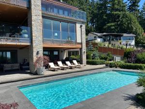 a swimming pool in front of a house at Luxury accomodation in West Vancouver in West Vancouver