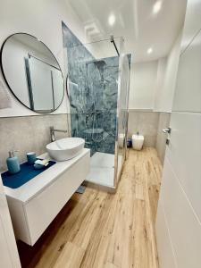 a bathroom with a sink and a shower at La Zisa Luxury Apartment in Palermo +36 photos