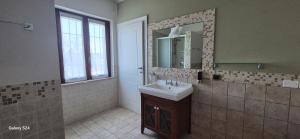 a bathroom with a sink and a mirror at Gardaworld Oasis in Cavalcaselle