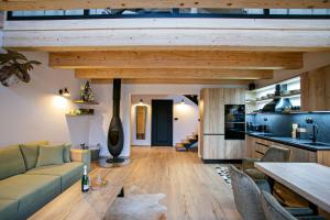 a living room with a couch and a table at Chalet pod Strážovom in Zliechov