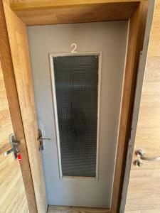 a door with a mesh window in a room at Studio St Florentin 2 in Saint-Florentin