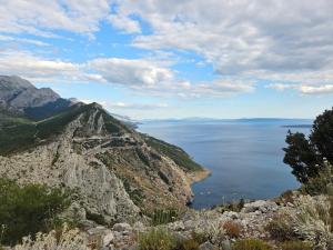 a view of the ocean from a mountain at Rajčić Apartmani in Omiš