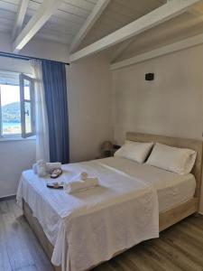 a bedroom with a large bed with towels on it at Blue Horizon Rock in Nydri