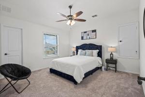 a bedroom with a bed and a ceiling fan at Rooftop Bliss 4BR with Crib Office space Fast Wifi Free Parking in Mesquite