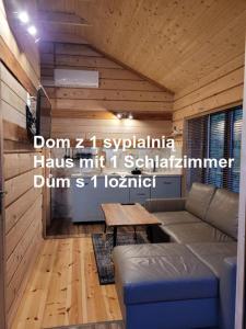 a living room with a couch and a table at Ośrodek Wypoczynkowy Feniks in Pogorzelica