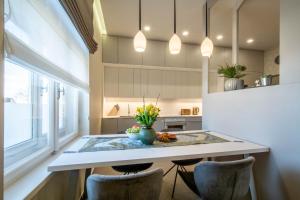 a kitchen with a table and some chairs at APARTMÁNY KOLLÁR so SAUNOU in Smokovce