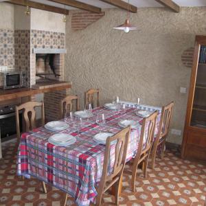 a dining room table with chairs and a table cloth at SueñoRural in San Miguel de Valero