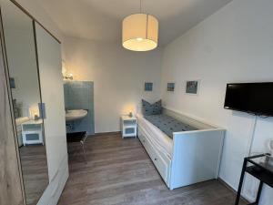 a bedroom with a bed and a sink in a room at Hotel Am Ehrenhof in Düsseldorf