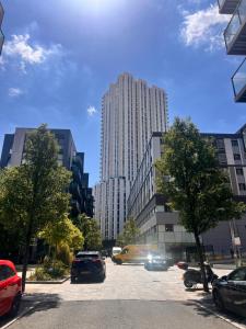 a parking lot in a city with tall buildings at Relaxing city base with great access to transport in London