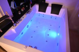 a hot tub in a room with a purple lighting at Gran Duca Santo Stefano Suite ZONA CASALE VICINO AEROPORTO in Brindisi