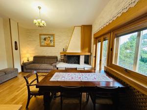 a living room with a table and a fireplace at Casa Vacanza Encanto in Roccaraso