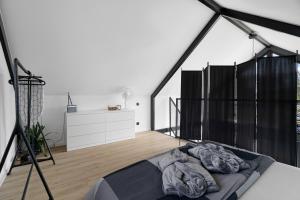 a bedroom with a bed in a room with black curtains at KASZUBSKI LOFT Sominy in Sominy