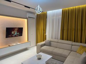 a living room with a couch and a table at City View Apartments in Durrës