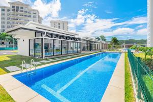 a swimming pool in front of a building at Viva Jaco Unit 0605 in Jacó