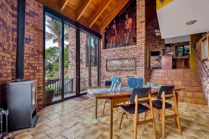 a dining room with a table and chairs and a stove at Melville Penthouse With Stunning Views in Johannesburg