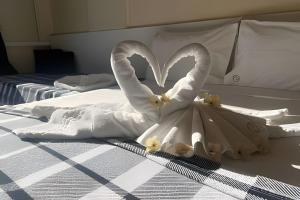 a swan made out of towels on a bed at FLAT-Cavalinho Branco-Águas de Lindoia in Águas de Lindóia