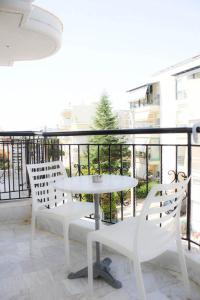 ein weißer Tisch und zwei Stühle auf einem Balkon in der Unterkunft StuDio 57 (5) in Alexandroupoli