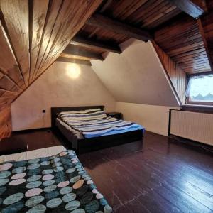 a bedroom with two beds in a attic at MARINASURF Baza Wypoczynkowa in Przeczyce
