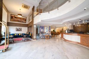 a lobby of a hotel with a bar and chairs at Hotel Palais Al Bahja in Marrakech