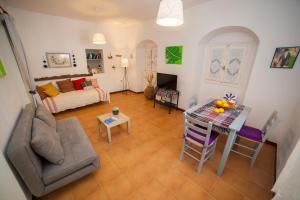 a living room with a couch and a table at Family Home PortoKatapola in Katapola