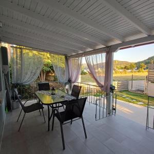 a dining room with a table and chairs on a patio at Casa Chinook Sea View Homes-Porto Koufo in Porto Koufo