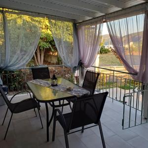a patio with a table and chairs on a balcony at Casa Chinook Sea View Homes-Porto Koufo in Porto Koufo