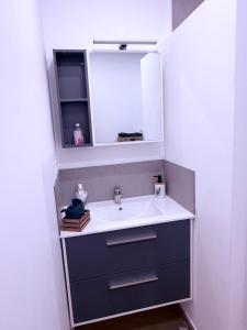 a bathroom with a sink and a mirror at Votre grand COCON Niçois Appart Vue Mer in Nice +21 photos
