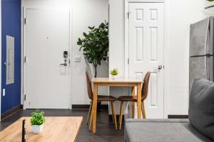 a dining room with a table and chairs and a door at CozySuites Gorgeous 1BR in Downtown Pitts #13 in Pittsburgh +4 photos