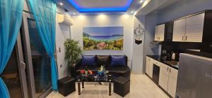 a living room with a couch and a painting on the wall at Perfect Suites in Neos Marmaras