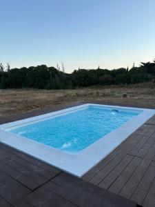 a swimming pool on a deck with blue water at Finca Dos Vientos Tarifa in Tarifa