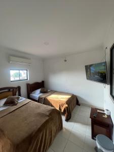 Postel nebo postele na pokoji v ubytování HOTEL IMPERIAL LA QUINTA