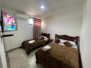Postel nebo postele na pokoji v ubytování HOTEL IMPERIAL LA QUINTA