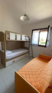 a bedroom with a bed and a bunk bed at Holiday House Gioia in Chia