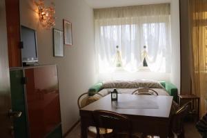 a room with a table and a bed and a window at Monika Holiday 619 Green Garda Lake in Garda