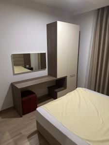 a bedroom with a dresser and a mirror at AB LUX Apartmani 406 in Kravlja