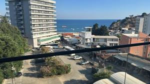 a view of a city with the ocean in the background at AB LUX Apartmani 406 in Kravlja